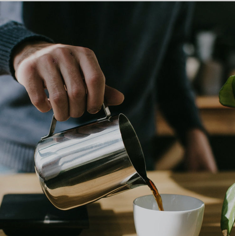 Coffee lover pouring a cup of Peet's coffee from a pitcher