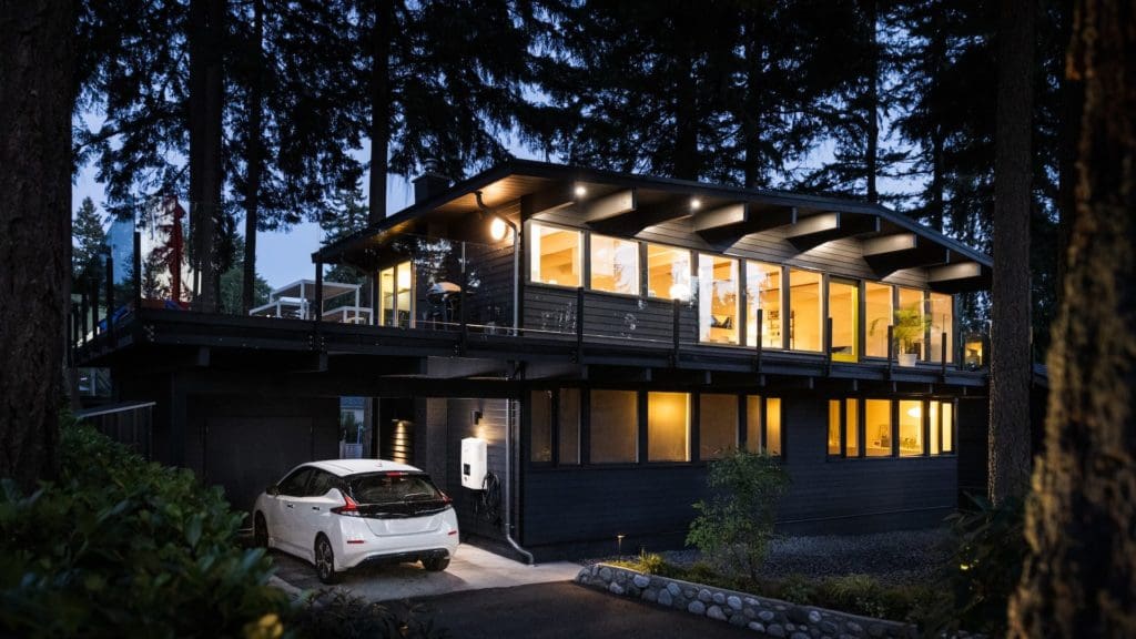 A house illuminated by lights during the nighttime.