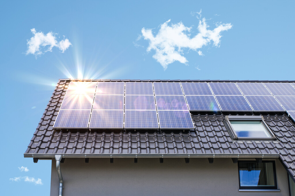 Residential solar system on black tile roof sun reflecting